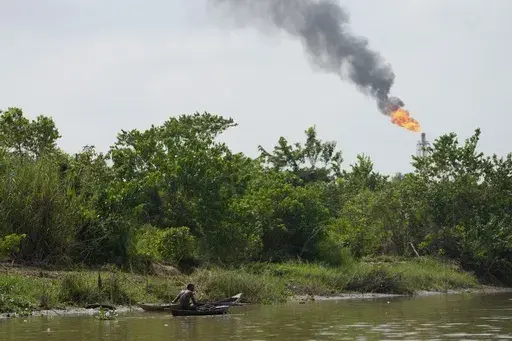 A man paddles his canoe in the Niger Delta near the village of Ogboinbiri, Nigeria, Dec. 11, 2024. (AP Photo/Sunday Alamba, File)