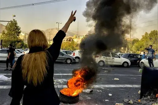 In this photo taken by an individual not employed by the Associated Press and obtained by the AP outside Iran, Iranians protests the death of 22-year-old Mahsa Amini after she was detained by the morality police, in Tehran, Oct. 1, 2022. In a report published by The Iranian student news agency, Nezamoddin Mousavi, an Iranian lawmaker said Sunday, Dec. 4, 2022, that Iran’s government was ‘‘paying attention to the people’s real demands,’’ a day after another key official announced that