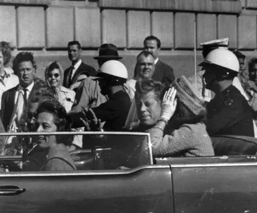 This Nov. 22, 1963 file photo shows President John F. Kennedy riding in motorcade with first lady Jacqueline Kenndy in Dallas, Texas. (AP Photo, file)