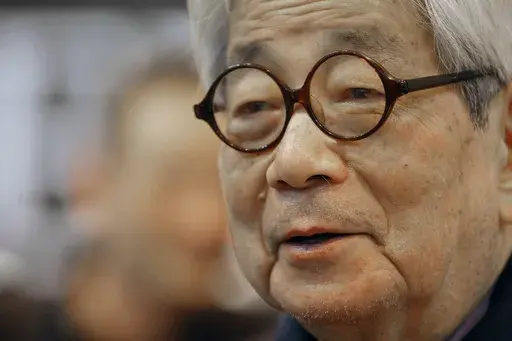 Japanese Nobel Prize winning author Kenzaburo Oe poses during the inauguration of the 32nd Paris Book Fair, which focused on Japanese writers, March 15, 2012. Japanese publisher Kodansha Ltd. said Monday, March 13, 2023 that Nobel literature laureate Kenzaburo Oe died of old age. Oe's darkly poetic novels were built from a childhood during Japan’s postwar occupation and parenthood with a disabled son. (AP Photo/Jacques Brinon, File)