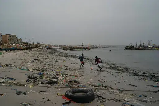Boys play soccer among trash that litters the sand of Yarakh Beach in Dakar, Senegal, Nov. 8, 2022. Reducing waste while boosting recycling and reuse, known as the ‘circular economy,’ will be vital for halting the loss of nature, organizers of the World Circular Economy Forum said Wednesday, Dec. 7. (AP Photo/Leo Correa, File)