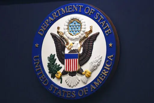 The State Department seal is seen on the briefing room lectern at the State Department in Washington, Jan. 31, 2022. Everyday Americans will be able to help refugees adjust to life in the U.S. in a program being launched by the State Department. The goal is to give private citizens a role in resettling the thousands of refugees who come to America every year. The State Department is calling the new program the Welcome Corps.(Mandel Ngan, Pool via AP, File)