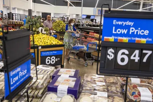 People buy groceries at a Walmart Superstore in Secaucus, New Jersey, July 11, 2024. (AP Photo/Eduardo Munoz Alvarez, File)