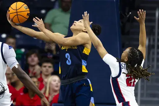 Marquette guard Rose Nkumu (3) drives past Mississippi guard Zakiya Stephenson (21) during the first half of a first-round college basketball game in the NCAA Tournament Saturday, March 23, 2024, in South Bend, Ind. (AP Photo/Michael Caterina)