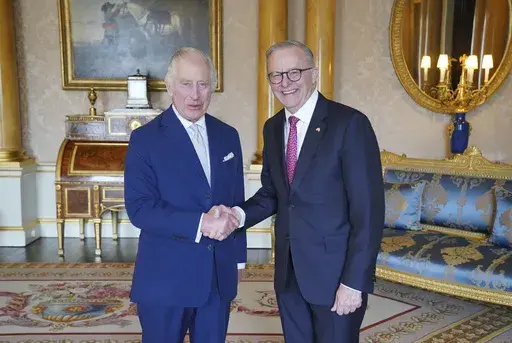 King Charles III, left, receives Australian Prime Minister Anthony Albanese, right, during an audience at Buckingham Palace in London, Britain, Tuesday May 2, 2023. (Jonathan Brady/Pool via AP)