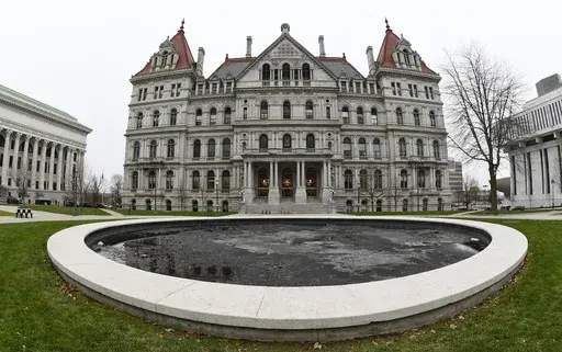 The New York state Capitol in Albany, N.Y., is pictured on Dec. 14, 2020. New York's minimum-wage workers had more than just the new year to celebrate Monday, Jan. 1, 2024, with a pay bump kicking in as the clock ticked over to 2024. In the first of a series of annual increases slated for the Empire State, the minimum wage increased to $16 in New York City and some of its suburbs, up from $15. In the rest of the state, the new minimum wage is $15, up from $14.20. (AP Photo/Hans Pennink, File)