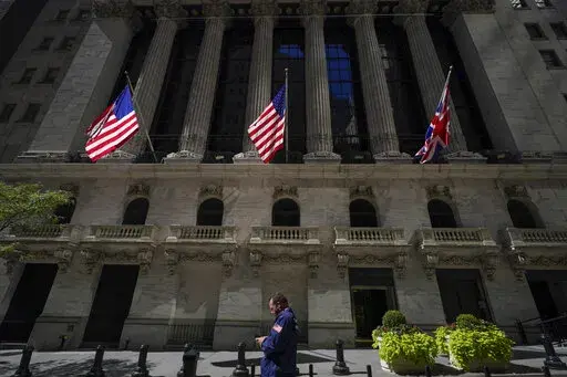 A trader looks over his cell phone outside the New York Stock Exchange, Wednesday, Sept. 14, 2022, in the financial district of Manhattan in New York.  Stocks are opening broadly lower on Wall Street, Friday, putting the market on track for another week of sizable losses, as a stark warning from FedEx about rapidly worsening trends in the economy gave investors more to worry about. (AP Photo/Mary Altaffer)
