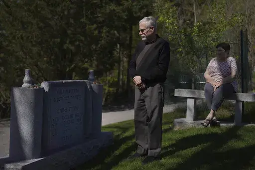Co-presidents of New Light Congregation, Stephen Cohen and Barbara Caplan, visit a memorial in the New Light Cemetery on Wednesday, April 19, 2023, in Shaler Township, Pa., honoring the congregants they lost during the Pittsburgh synagogue massacre over four years ago. Jury selection is scheduled to begin on Monday, April 24, for the suspect accused of invading the Tree of Life synagogue building on that Sabbath morning and murdering 11 worshippers from three congregations. (AP Photo/Jessie Ward