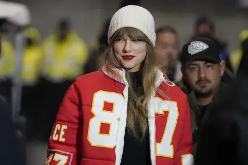 Taylor Swift wears a Kansas City Chiefs tight end Travis Kelce jacket as she arrives before an NFL wild-card playoff football game between the Chiefs and the Miami Dolphins, Saturday, Jan. 13, 2024, in Kansas City, Mo. A scourge of pornographic deepfake images generated by artificial intelligence and sexualizing people without their consent has hit its most famous victim, singer Taylor Swift, drawing attention to a problem that tech platforms and anti-abuse groups have struggled to solve. (AP Ph