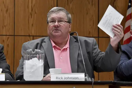 Rick Johnson chairs the committee as it meets before a capacity crowd in Lansing, Mich., June 26, 2017, at the first open meeting of the Michigan Medical Marijuana Board. Federal authorities said Thursday, April 6, 2023, that Johnson, the former head of a Michigan medical marijuana licensing board, accepted more than $100,000 in bribes and has agreed to plead guilty. (Dale G Young/Detroit News via AP, File)