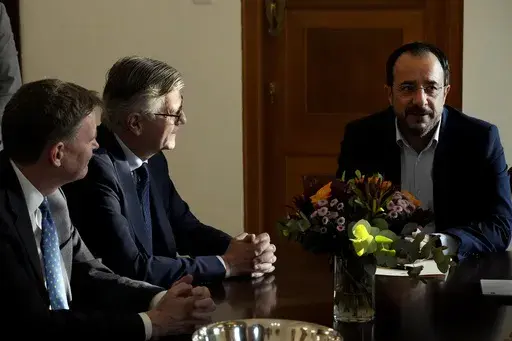 UN Under-Secretary-General for Peacekeeping Operations Jean-Pierre Lacroix, center, and U.N. Secretary General's Special Representative in Cyprus Colin Stewart, left, talk with Cyprus' with Cyprus' President Nikos Christodoulides during their meeting in divided capital Nicosia, Cyprus, on Wednesday, Nov. 1, 2023. Lacroix is in Cyprus for three-day visit. (AP Photo/Petros Karadjias)