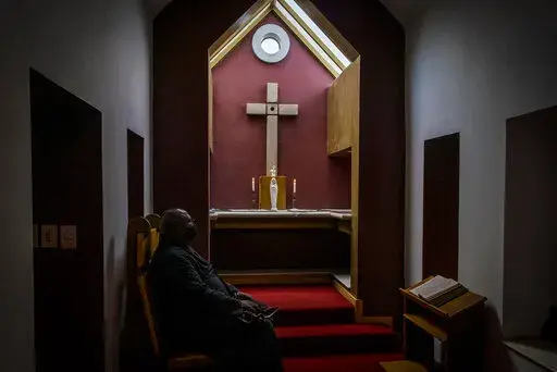Arch Deacon Sepadi Moruthane inside Anglican Archbishop Emeritus Desmond Tutu's private chapel at the Soweto home. Wednesday, Dec. 29, 2021. The Nobel Peace Prize-winning activist for racial equality and LGBT rights died Sunday at the age of 90. (AP Photo/Shiraaz Mohamed)