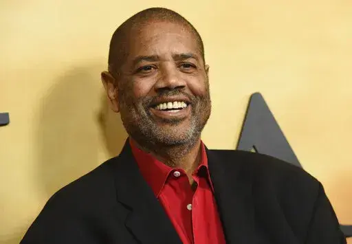 Gregory Allen Howard arrives at the Los Angeles premiere of "Harriet" on Oct. 29, 2019. Howard, who skillfully adapted stories of historical Black figures in “Remember the Titans” starring Denzel Washington, “Ali” with Will Smith and “Harriet” with Cynthia Erivo, died Friday at a hospital in Miami of heart failure, according to publicist Jeff Sanderson. He was 70. (Photo by Chris Pizzello/Invision/AP, File)