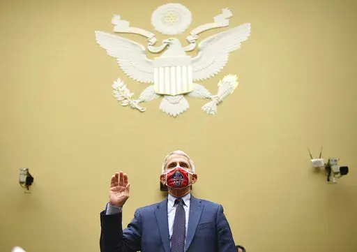 Dr. Anthony Fauci, director of the National Institute for Allergy and Infectious Diseases, is sworn in before a House Subcommittee on the Coronavirus crisis hearing, July 31, 2020 on Capitol Hill in Washington. Fauci steps down from a five-decade career in public service at the end of the month, one shaped by the HIV pandemic early on and the COVID-19 pandemic at the end. (Kevin Dietsch/Pool via AP, File)
