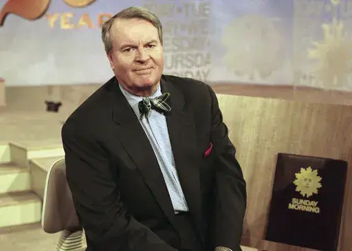 Charles Osgood, anchor of CBS's "Sunday Morning," poses for a portrait on the set in New York on March 28, 1999. Osgood, who anchored the popular news magazine's for more than two decades, was host of the long-running radio program “The Osgood File” and was referred to as CBS News’ poet-in-residence, has died. He was 91. (AP Photo/Suzanne Plunkett, File)