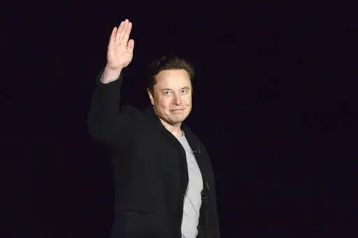 SpaceX's Elon Musk waves while providing an update on Starship, on Feb. 10, 2022, near Brownsville, Texas. Twitter on Thursday, Dec. 15, 2022, suspended the accounts of journalists who cover the social media platform and Musk, including reporters working for The New York Times, Washington Post, CNN and other publications (Miguel Roberts/The Brownsville Herald via AP, File)