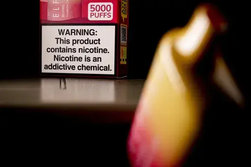 A health warning is seen on the packaging of a disposable vaping pod device in Washington on Monday, June 26, 2023. Sixty years ago, the U.S. surgeon general released a report that settled a longstanding public debate about the dangers of cigarettes and led to huge changes in smoking in America. Some public health experts say a similar report could help clear the air about vaping.(AP Photo/Andrew Harnik, File)