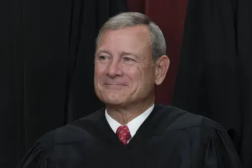 Chief Justice of the United States John Roberts joins other members of the Supreme Court as they pose for a new group portrait, at the Supreme Court building in Washington, Oct. 7, 2022. Roberts has declined an invitation to meet with Democratic senators to talk about Supreme Court ethics and the controversy over flags that flew outside homes owned by Justice Samuel Alito. (AP Photo/J. Scott Applewhite, File)