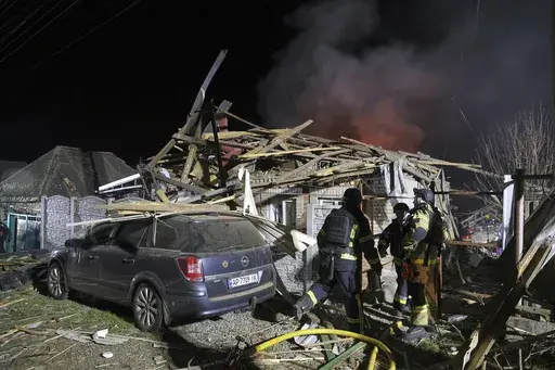 Rescuers work on site of a residential building destroyed by a Russian drone strike in Zaporizhzhia, Ukraine, March 21, 2025. (AP Photo/Kateryna Klochko, File)