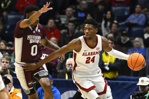 CORRECTS THE PLAYER AT LEFT TO MISSISSIPPI STATE FORWARD DJ JEFFRIES AND NOT ARKANSAS GUARD ANTHONY BLACK - Alabama forward Brandon Miller (24) fends off defense by Mississippi State forward DJ Jeffries (0) during the first half of an NCAA college basketball game in the third round of the Southeastern Conference tournament, Friday, March 10, 2023, in Nashville, Tenn. (AP Photo/John Amis)
