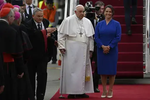 Pope Francis is greeted by Hungary President Katalin Novak during the farewell ceremony at the Budapest International Airport in Budapest, Hungary, Sunday, April 30, 2023. (AP Photo/Denes Erdos)
