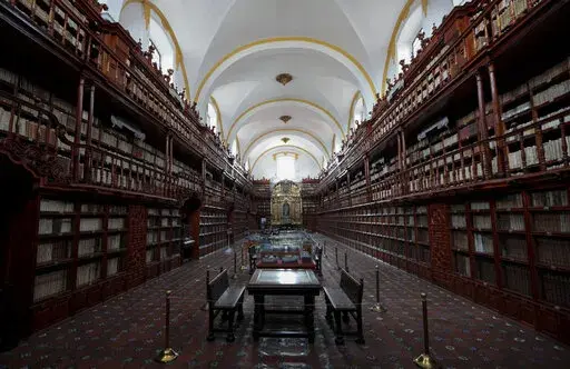 The interior of Palafoxiana library in Puebla, Mexico, Tuesday, Sept. 13, 2022. It is the oldest public library in the Americas, according to UNESCO. (AP Photo/Pablo Spencer)