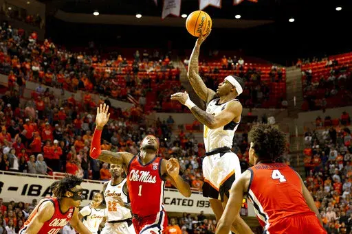 Oklahoma State's Avery Anderson III, second from right, shoots over Mississippi's Amaree Abram (1) during the first half of an NCAA college basketball game in Stillwater, Okla., Saturday, Jan. 28, 2023. (AP Photo/Mitch Alcala)