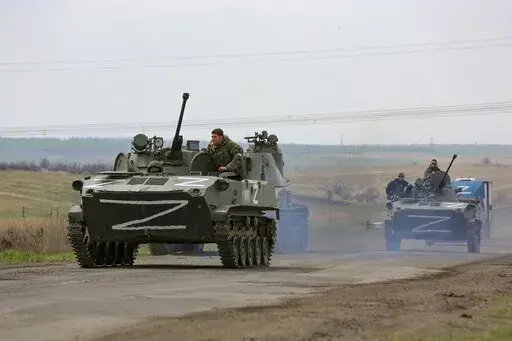 Russian military vehicles move on a highway in an area controlled by Russian-backed separatist forces near Mariupol, Ukraine, April 18, 2022. Mariupol, a strategic port on the Sea of Azov, has been besieged by Russian troops and separatist forces in eastern Ukraine for more than six weeks. (AP Photo/Alexei Alexandrov, File)