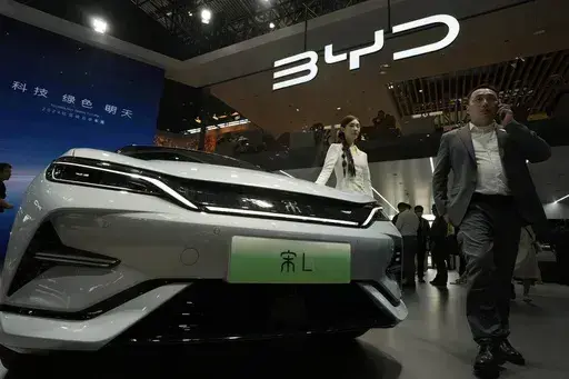 A model poses near the BYD Song L EV car during Auto China 2024 held in Beijing, April 25, 2024. (AP Photo/Ng Han Guan, File)