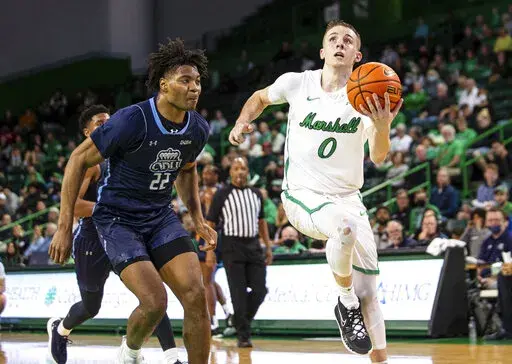 Marshall's Andrew Taylor (0) drives to the rim against Old Dominion's Kalu Ezikpe (22) during an NCAA men's basketball game on Thursday, Feb. 17, 2022, at the Cam Henderson Center in Huntington./The Herald-Dispatch via AP)