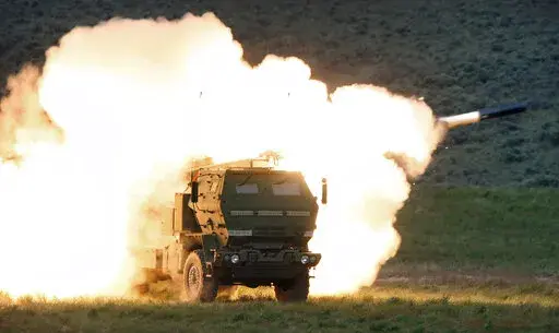 In this May 23, 2011, file photo a launch truck fires the High Mobility Artillery Rocket System (HIMARS) produced by Lockheed Martin during combat training in the high desert of the Yakima Training Center, Wash. The Biden administration is expected to announce it will send Ukraine a small number of high-tech, medium range rocket systems, U.S. officials said Tuesday. One official said the plan is to send Ukraine the HIMARS. (Tony Overman/The Olympian via AP, File)