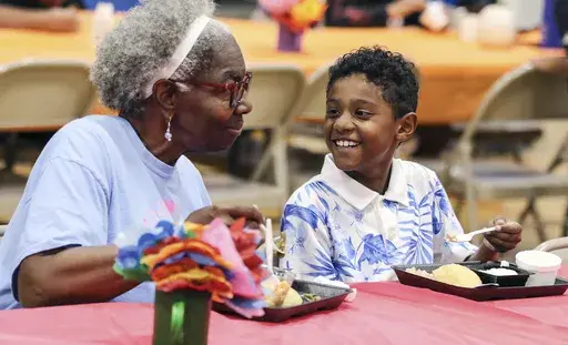 Third-grader Dallin Curry, 8, smiles as he talks with his grandmother, Mary Durr, Sept. 6, 2024, during a Grandparents Day celebration in the lunchroom at Burns Elementary School in Owensboro, Ky. (Alan Warren/The Messenger-Inquirer via AP, File)