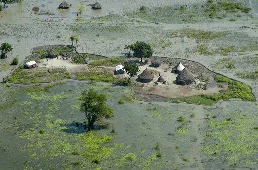 Thatched huts surrounded by floodwaters are seen from the air in Old Fangak county, Jonglei state, South Sudan, Nov. 27, 2020. South Sudan's President Salva Kiir Mayardit ordered the suspension Saturday, July 9, of all dredging-related activities in the country until evidence-based studies are carried out on their on surrounding communities and the ecosystems they rely on. (AP Photo/Maura Ajak, File)