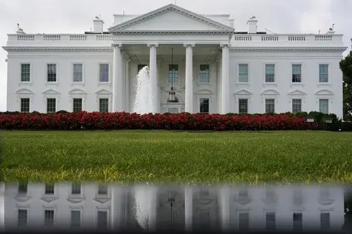 The White House is seen reflected in a puddle, Saturday, Sept. 3, 2022, in Washington. With roughly a year and a half until the 2024 presidential contest, the field of candidates is largely set. Former President Donald Trump and Florida Gov. Ron DeSantis have dominated the early Republican race, but other candidates including former Vice President Mike Pence, former United Nations Ambassador Nikki Haley and U.S. Sen. Tim Scott of South Carolina are looking for an opening in case either falters. 