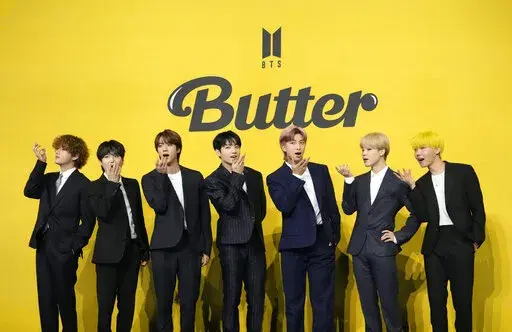 FILE- Members of South Korean K-pop band BTS, V, SUGA, JIN, Jung Kook, RM, Jimin, and j-hope from left to right, pose for photographers ahead of a press conference to introduce their new single "Butter" in Seoul, South Korea, May 21, 2021. The members of K-pop band BTS will serve their mandatory military duties under South Korean law, their management company said Monday, Oct. 17, 2022, effectively ending a debate on exempting them because of their artistic accomplishments. (AP Photo/Lee Jin-man