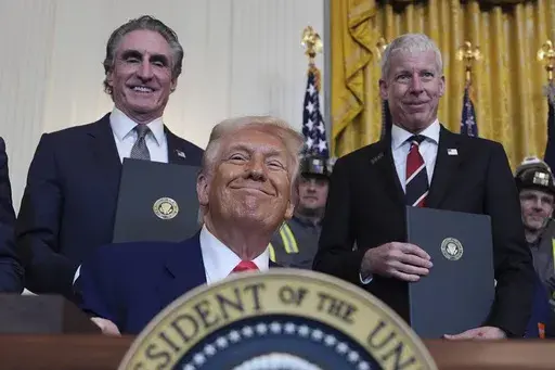 President Donald Trump smiles as he signs executive orders during an event in the East Room of the White House, Tuesday, April 8, 2025, in Washington, as Interior Secretary Doug Burgum and Energy Secretary Chris Wright watch. (AP Photo/Evan Vucci)