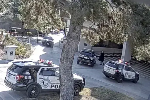 This image from campus surveillance video released by University of Nevada, Las Vegas, Thursday, March 28, 2024, shows gunman Anthony Polito, right, moments before being fatally shot by a UNLV campus police officer on Dec. 6, 2023, on the campus in Las Vegas. (University of Nevada, Las Vegas via AP)