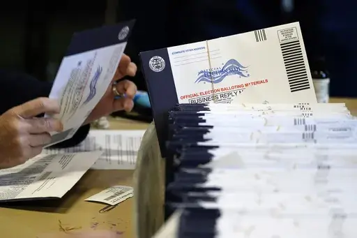 Chester County, Pa., election workers process mail-in and absentee ballots, in West Chester, Pa., Nov. 4, 2020. (AP Photo/Matt Slocum, File)