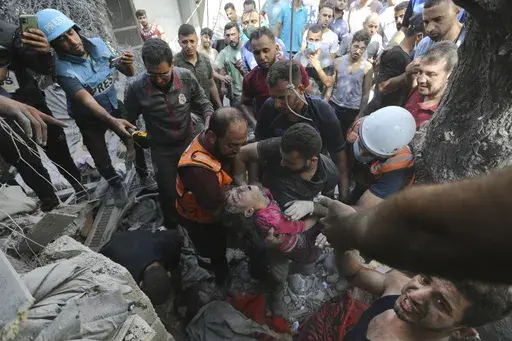 Palestinians rescue a child from under the rubble after Israeli airstrikes in Gaza City, Gaza Strip, Wednesday, Oct. 18, 2023. Israel's war on Hamas in the Gaza Strip has the Mideast simmering, raising the temperature on tensions across the region and increasing the risk that seemingly localized conflicts could spin out of control. (AP Photo/Abed Khaled, File)