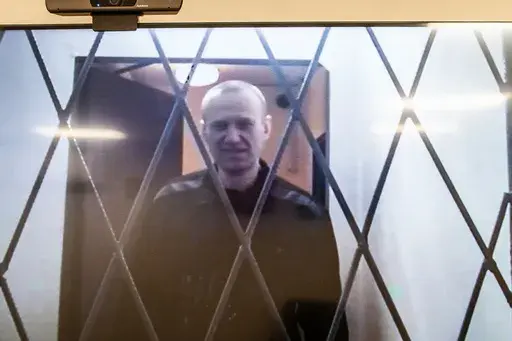 Russian opposition leader Alexei Navalny is seen on a TV screen as he appears in a video link provided by the Russian Federal Penitentiary Service from the courtroom in Kovrov, Vladimir region, about 240 kilometers (150 miles) east of Moscow, Russia, Wednesday, Jan. 10, 2024. Navalny, 47, is jailed on charges of extremism. He had been imprisoned in the Vladimir region of central Russia, but was transferred last month to a "special regime" penal colony — the highest security level of prisons in