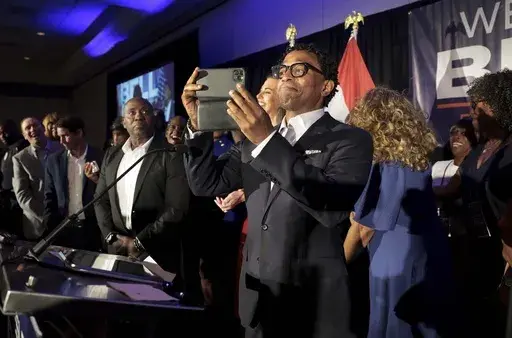 Wesley Bell takes a video of his supporters as he takes the stage as the winner of the Democratic congressional primary against incumbent U.S. Rep. Cori Bush on Tuesday, Aug. 6, 2024, in St. Louis. (Robert Cohen/St. Louis Post-Dispatch via AP)
