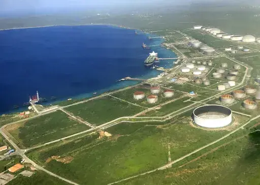 The Bullenbaai oil terminal sits along the coast of the Dutch Caribbean island of Curacao near Willemstad, Dec. 24, 2016. The terminal is at the center of an effort by Venezuela to get around U.S. sanctions, the Associated Press has learned. (AP Photo/Dick Drayer)