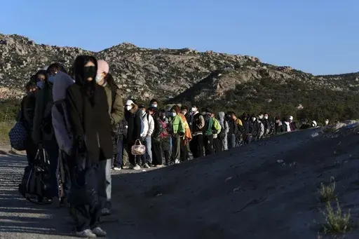 Chinese migrants wait to be processed after crossing the border with Mexico on May 8, 2024, near Jacumba Hot Springs, Calif. Arrests for illegally crossing the border from Mexico plunged 29% in June to the lowest month of Joe Biden's presidency, according to figures released Monday, July 15, 2024, that provide another window on the impact of a new rule to temporarily suspend asylum. (AP Photo/Ryan Sun,File)