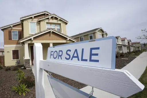 A for sale sign is posted in front of a home in Sacramento, Calif., Thursday, March 3, 2022. HomeServices of America, a real estate company owned by Warren Buffett’s Berkshire Hathaway, has agreed to pay $250 million to settle lawsuits nationwide claiming that longstanding practices by real estate brokerages forced U.S. homeowners to pay artificially inflated broker commissions when they sold their homes. (AP Photo/Rich Pedroncelli, File)