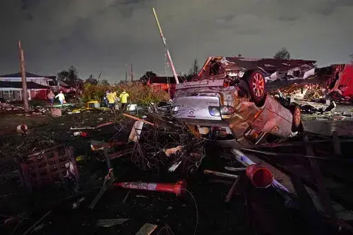 A car is flipped over after a tornado tore through the area in Arabi, La., Tuesday, March 22, 2022, in a part of the city that had been heavily damaged by Hurricane Katrina 17 years earlier. A United Nations report released on Monday, April 25, 2022, says disasters are on the rise are just going to get worse. A new UN report says the number of disasters, from climate change to COVID-19, are going to jump to about 560 a year by 2030. (AP Photo/Gerald Herbert, File)