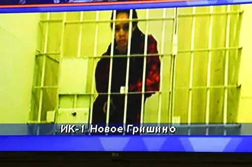 WNBA star and two-time Olympic gold medalist Brittney Griner is seen on the bottom part of a TV screen as she waits to appear in a video link provided by the Russian Federal Penitentiary Service a courtroom prior to a hearing at the Moscow Regional Court in Moscow, Russia, Tuesday, Oct. 25, 2022. A Russian court on Tuesday started hearing American basketball star Brittney Griner's appeal against her nine-year prison sentence for drug possession. (AP Photo/Alexander Zemlianichenko)