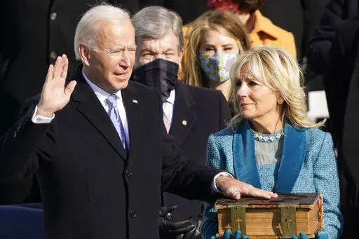 Joe Biden is sworn in as the 46th president of the United States by Chief Justice John Roberts as Jill Biden holds the Bible during the 59th Presidential Inauguration at the U.S. Capitol in Washington, Jan. 20, 2021. (AP Photo/Andrew Harnik, File)