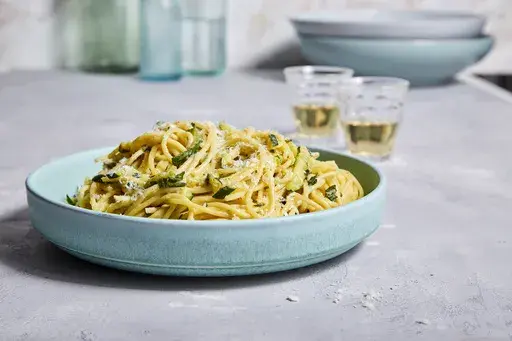 This image released by Milk Street shows a recipe for pasta with pecorino-zucchini sauce and basil. (Milk Street via AP)