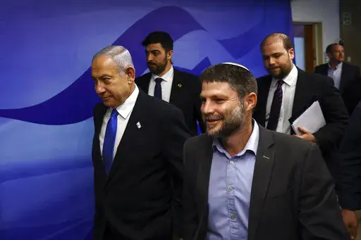 Israeli Prime Minister Benjamin Netanyahu, left, and Finance Minister Bezalel Smotrich, right, arrive to attend a cabinet meeting at the Prime Minister's office in Jerusalem, Thursday, Feb. 23, 2023. (Ronen Zvulun/Pool Photo via AP)