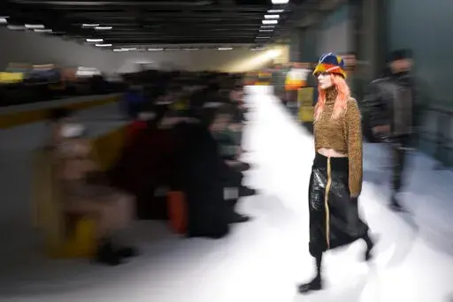 Models wear creations as part of the K-Way men's Fall-Winter 2022-23 collection, unveiled during the Fashion Week in Milan, Italy, Monday, Jan. 17, 2022. (AP Photo/Antonio Calanni)